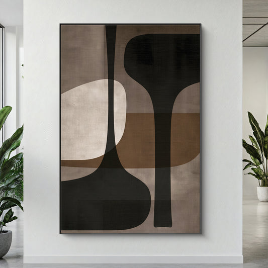 Framed canvas print with tall sculptural forms in charcoal, taupe and warm brown — mid-century modern wall art in a floating frame
