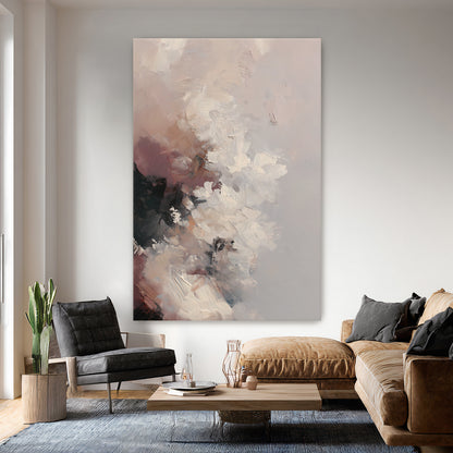 Living room with a large abstract painting on the wall, brown sofa, and gray armchair.
