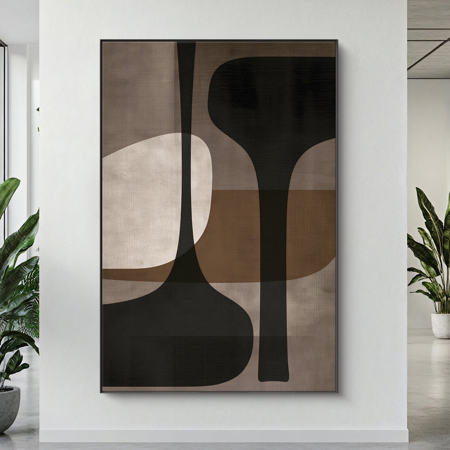 Framed canvas print with tall sculptural forms in charcoal, taupe and warm brown — mid-century modern wall art in a floating frame