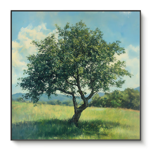 Framed canvas print of a solitary full-canopy tree in a bright green meadow with blue sky and rolling hills — nature wall art in a black floating frame