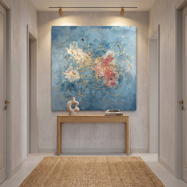 Gallery-wrapped stretched canvas with gold drip splatter and rose accents on a soft cerulean blue ground — expressive artistic wall art ready to hang